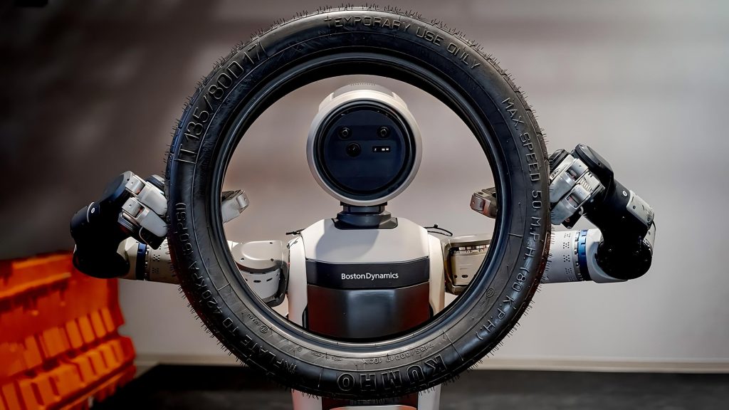 Atlas robot by Boston Dynamics holding up a tyre as the humanoid robot showcases a new approach to learning complex new tasks using a human-watching AI model.